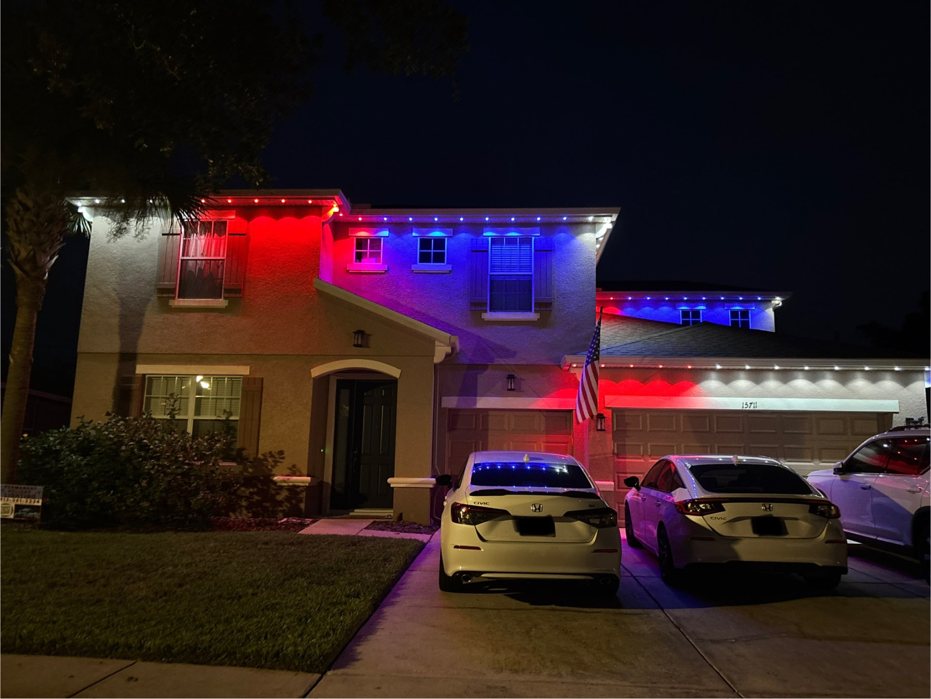 Stucco home lit in patriotic red, white, and blue permanent LEDs