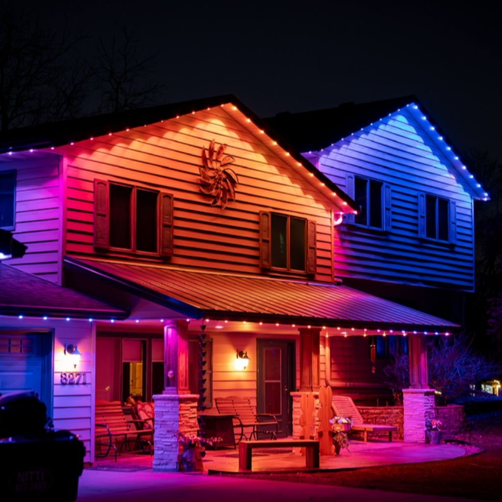 Home lit in red, orange, and blue permanent LED colors at night