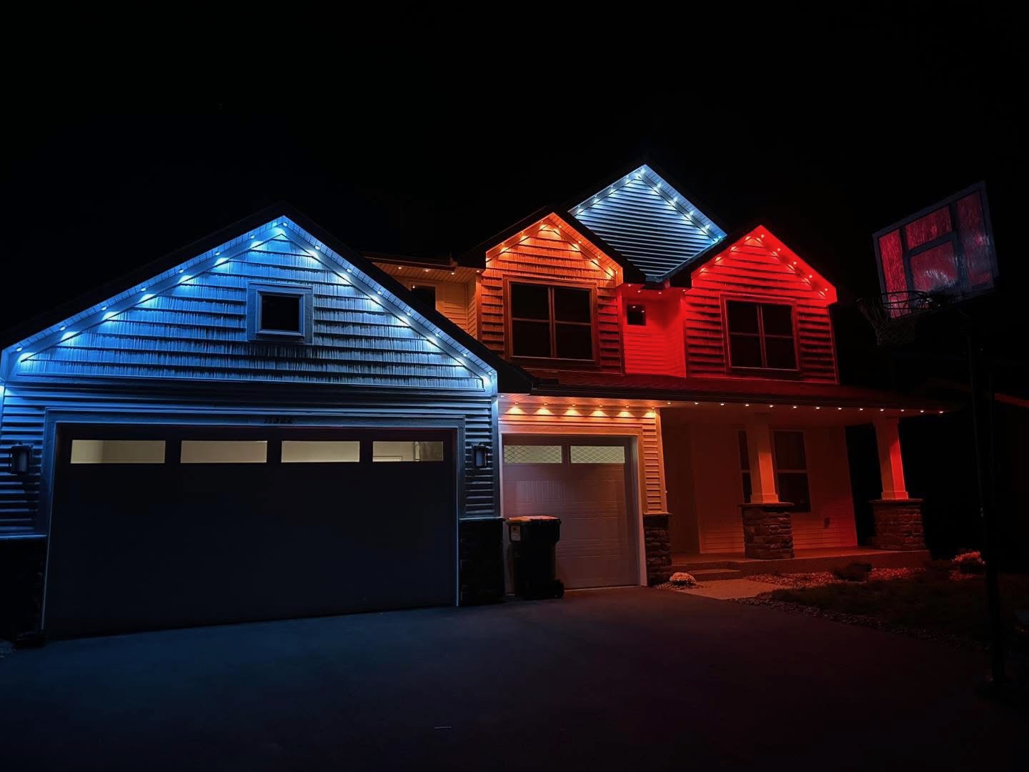 Home with blue, white, and red permanent LED gable lighting